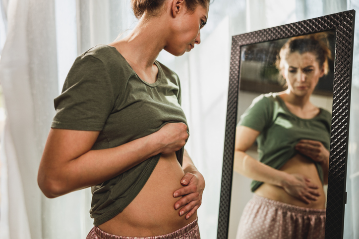 Woman Suffering From Stomach Cramps