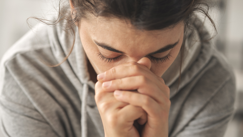 Sad young woman dealing with loss and psychological trauma