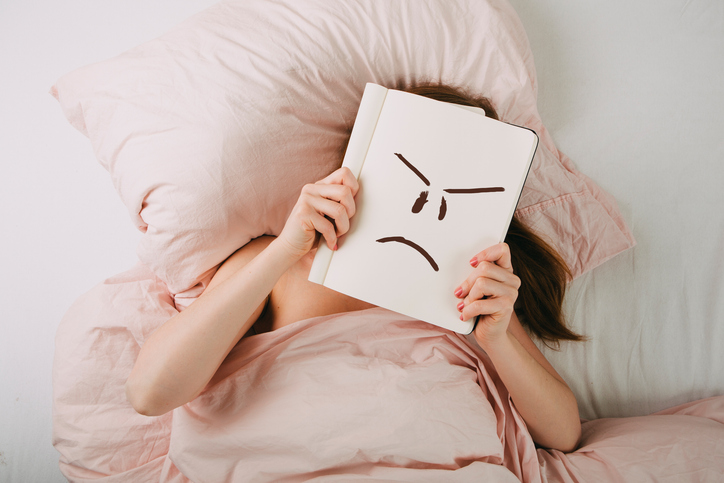 Young woman relaxing in bed