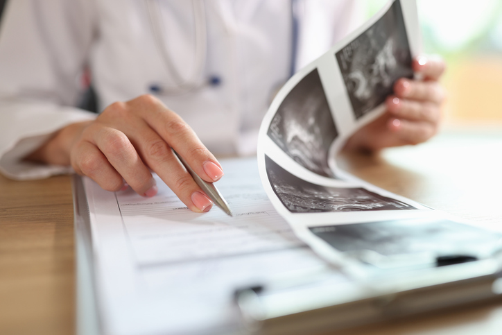 Gynecologist examines results of examination of uterus
